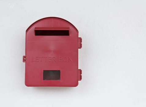 Red mailbox on white wall background at Malaysia