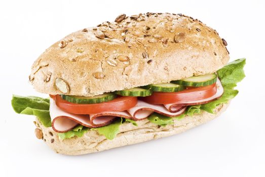 Freshly made sandwich with ham and vegetables over white