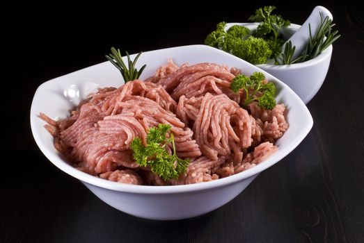 Bowl of raw minced pork with mortar and pestle