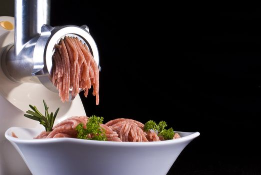 Bowl of mince with electric meat grinder