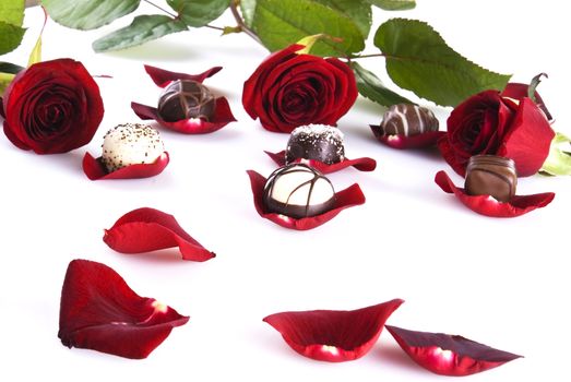 Luxury chocolates on roses petals and roses