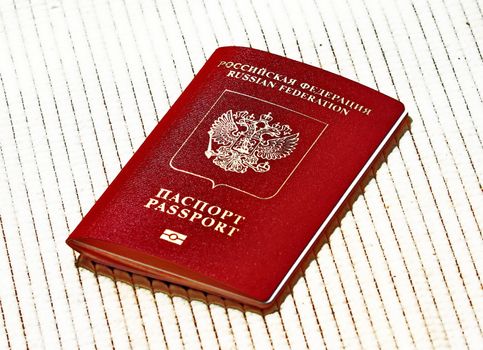 Russian passport in red with gold lettering to travel abroad on a 
beige background