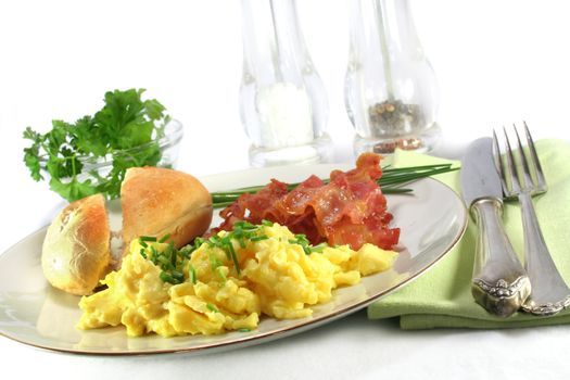 a plate of scrambled eggs with bacon