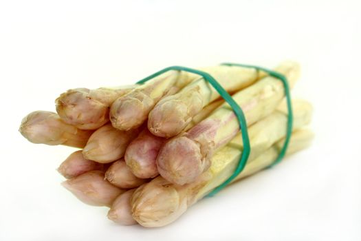 a bundle of fresh asparagus on a white background