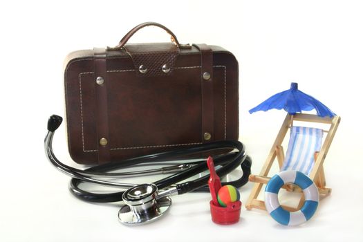 Stethoscope and suitcase on a white background