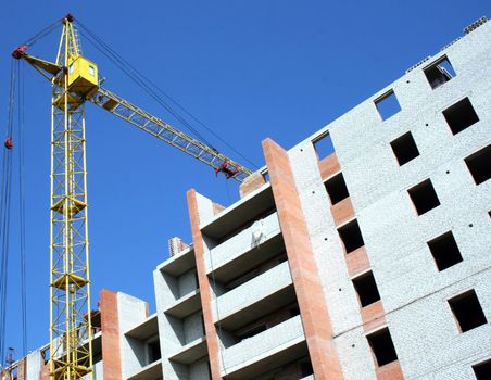 Building - the crane near the under construction brick house