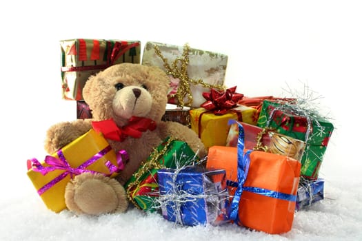 Teddy with colorful gifts in the snow