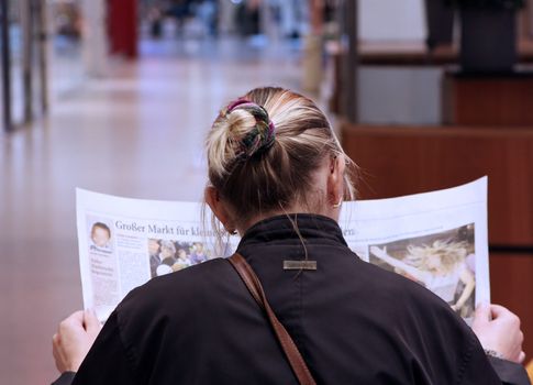 woman reads Newspaper