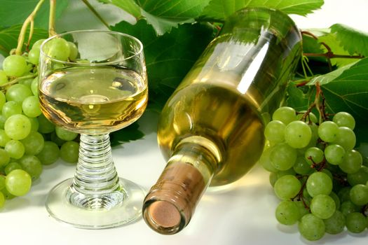 two bottles of wine with grapes and leaves