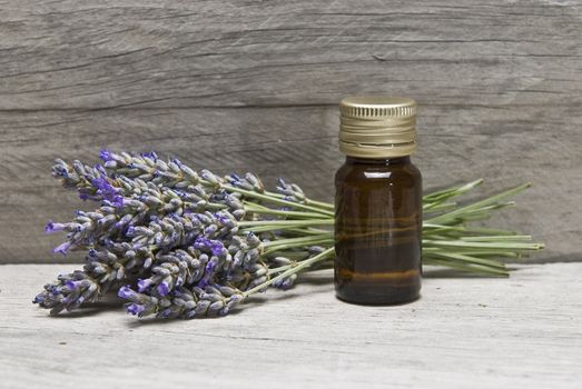 Lavender and some hygiene items made of lavender on an old wooden shelf.