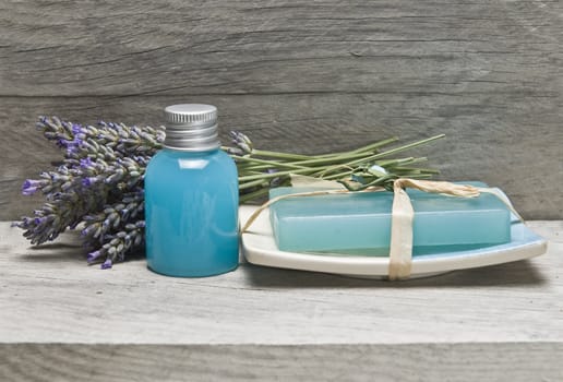 Lavender and some hygiene items made of lavender on an old wooden shelf.