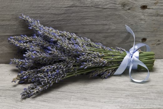 A bouquet of lavender on a wooden shelf.