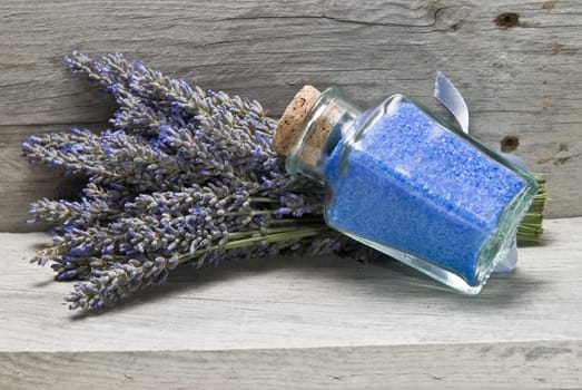 Lavender and some hygiene items made of lavender on an old wooden shelf.