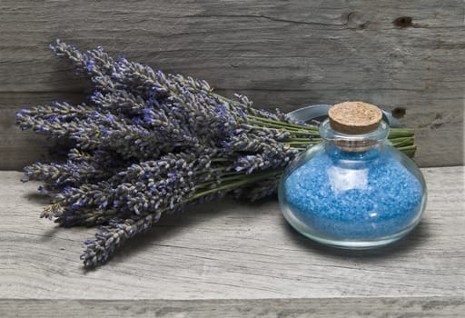 Lavender and some hygiene items made of lavender on an old wooden shelf.