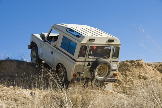 Enjoying driving a classic 4x4 car off road.