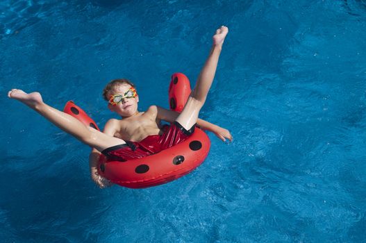 Young boy with attitude showing floating in a pool