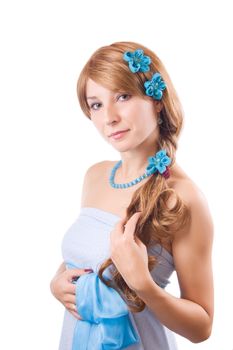 Woman in blue dress with flowers in hair over white