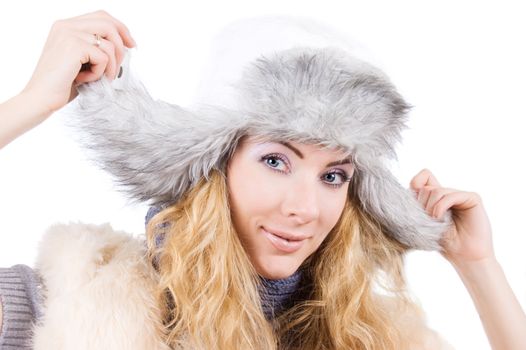 Smiling woman in fur gray hat over white