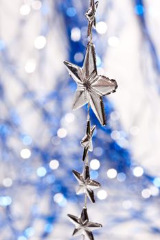 Holiday series: christmas silver stars on the shiny garland background