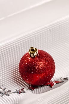 Holiday series: christmas red ball over white