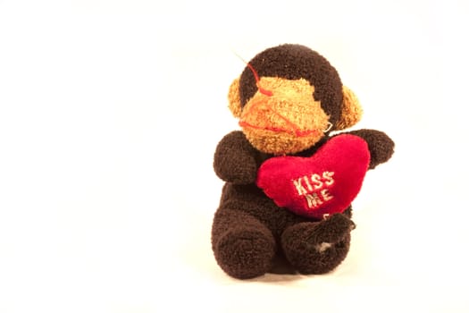 A toy monkey with a heart