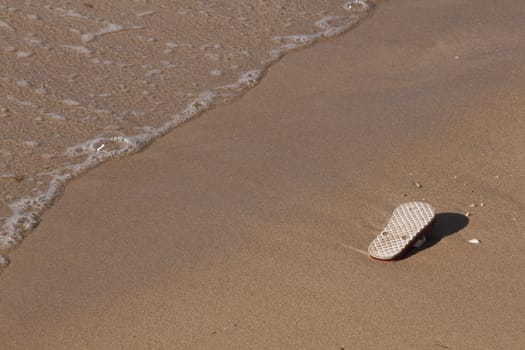 abandoned flip flop on the beach