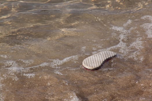 abandoned flip flop on the beach