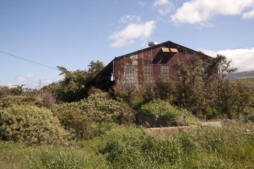 Old abandoned rusty tropical barn.