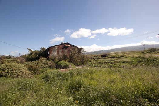 Old abandoned rusty tropical barn.