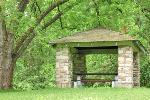 Picnic shelter in a park in the summer months.