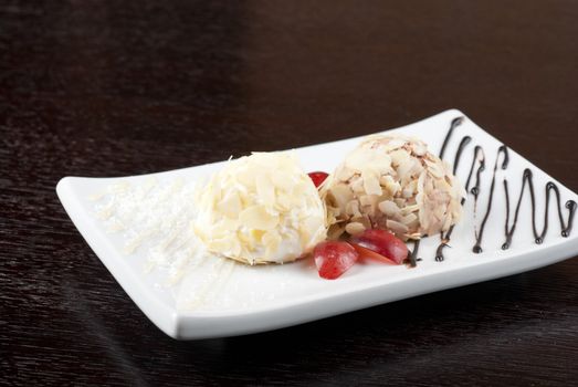 Dessert set of ice-cream with almond, chocolate and grapes