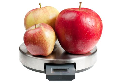 Three red apples on a scales isolated over white background. Diet concept