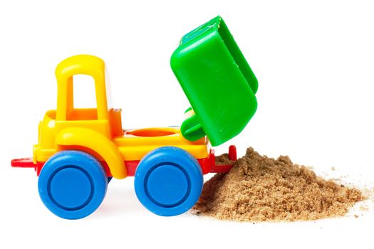 Colorful toy truck with sand isolated over white background