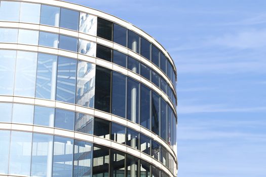 Modern round building on blue sky background