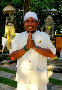 A Balinese man wearing traditional attire, at a temple in Nusa Dua, Bali, Indonesia.