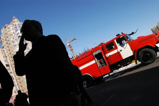 Man smoking in front of fire truck 