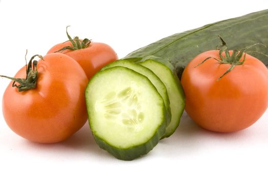 fresh tomatoes and a cucumber with slices