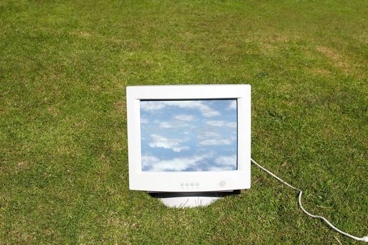 computer monitor on the grass depicting outsourcing