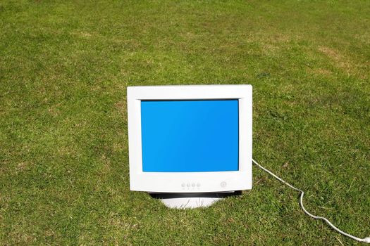 computer monitor on the grass depicting outsourcing