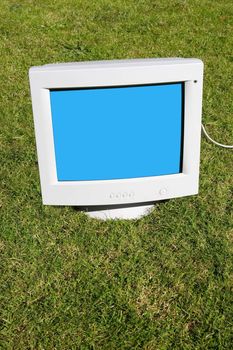 computer monitor on the grass depicting outsourcing