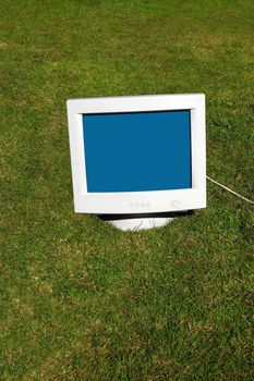 computer monitor on the grass depicting outsourcing