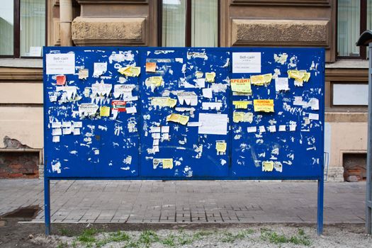 street billboard with paper advertising and announcement