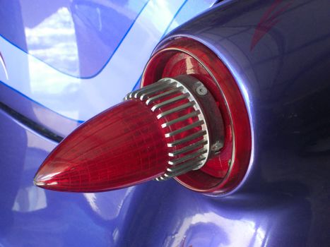 This tail light is shaped like a bullet and it belongs to a 1954 streetrod