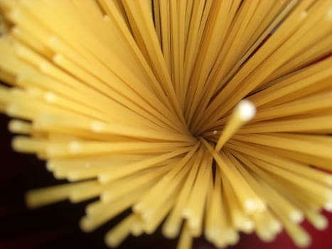 bird`s eye view of unboiled spaghetti, one of them outstanding 