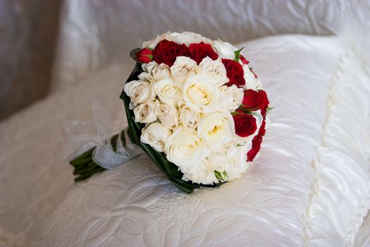 bouquet of the bride on the bed