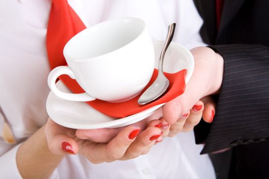 white cup in hands of the girl and a man in business wear