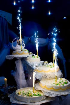 flaring candles over the wedding cake