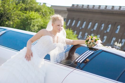 happy bride near to the car