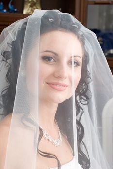 smiling bride under a veil