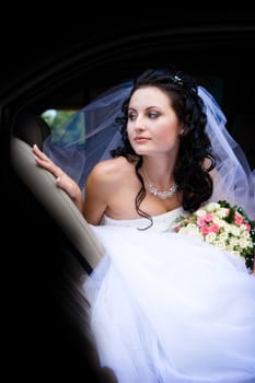 Portrait of the bride sitting in the car
